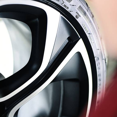 Close-up of a car wheel with detailed tire tread and alloy rim.