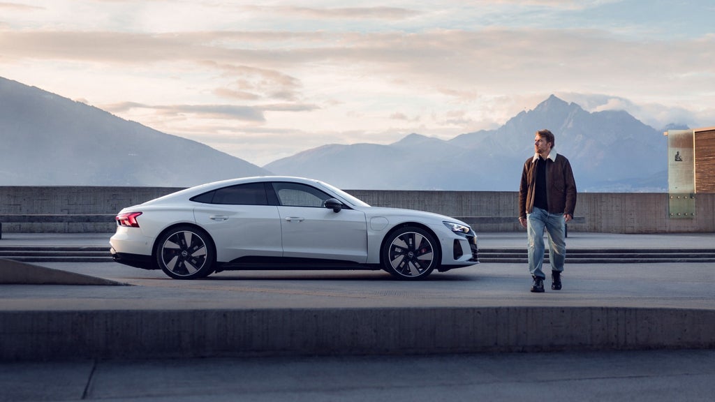 Aleksandr Kilde walking past his parked Audi.