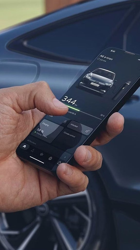 An Audi vehicle interior with a digital dashboard displaying navigation and multiple functions