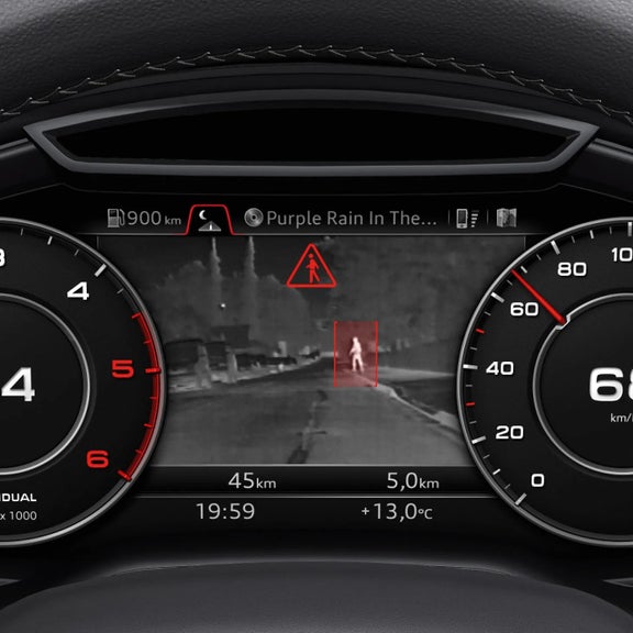 Car dashboard displaying speedometer, tachometer, and heads-up display with pedestrian warning.