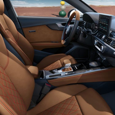 Car interior with brown leather seats, modern dashboard, and steering wheel.