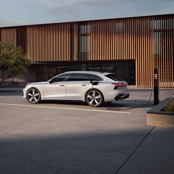 White A6 Avant e-hybrid plugged in an EV charger
