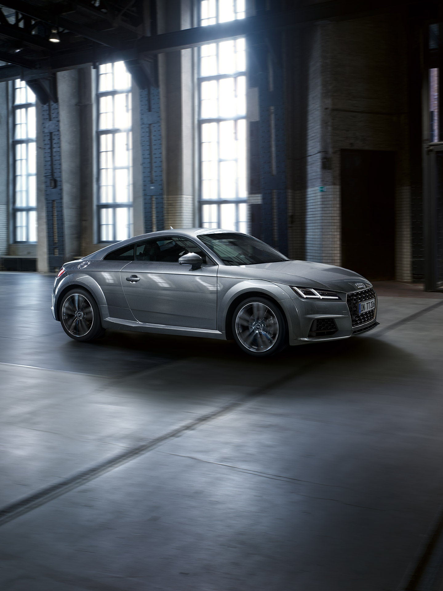Silver Audi TT in an empty building.