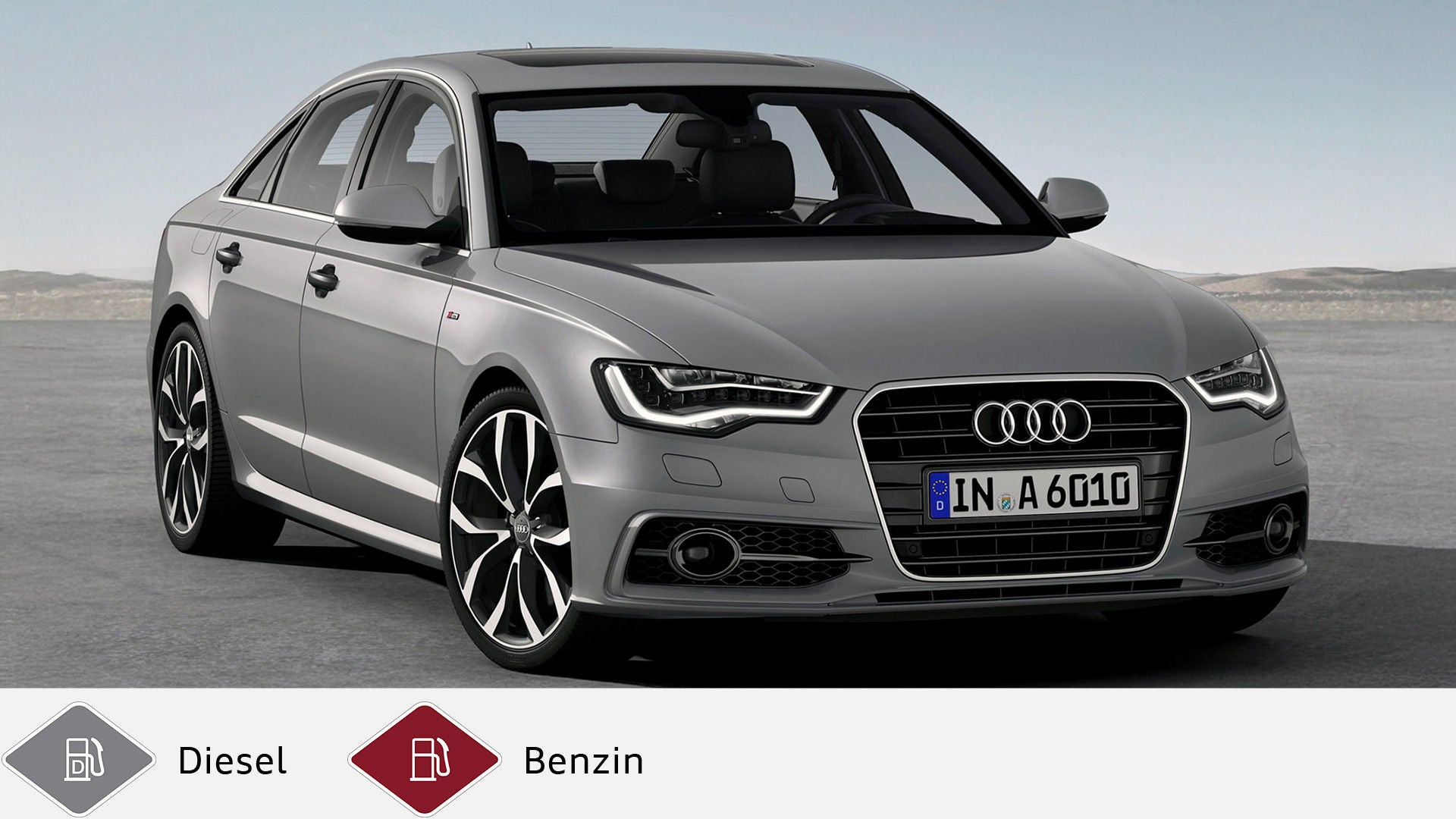 Grauer Audi A6 Limousine (2011–2018) stehend in weitem, offenen Gelände. Unten graues Dieselsymbol und rotes Benzinsymbol.