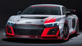 Audi R8LMS GT4 sports car in silver with red accents and Audi Sport branding