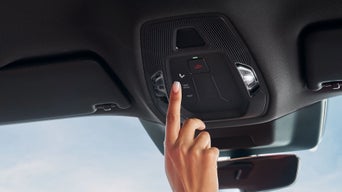 Der Zeigefinger einer Frau betätigt die Service-Call-Taste.