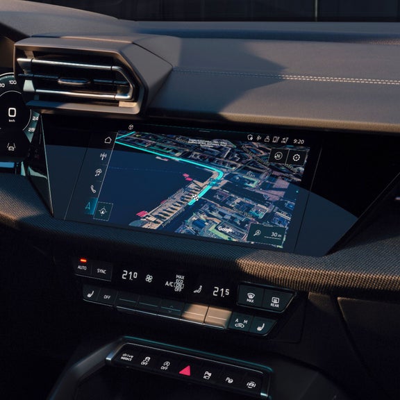 Audi car dashboard with a navigation touch screen display.