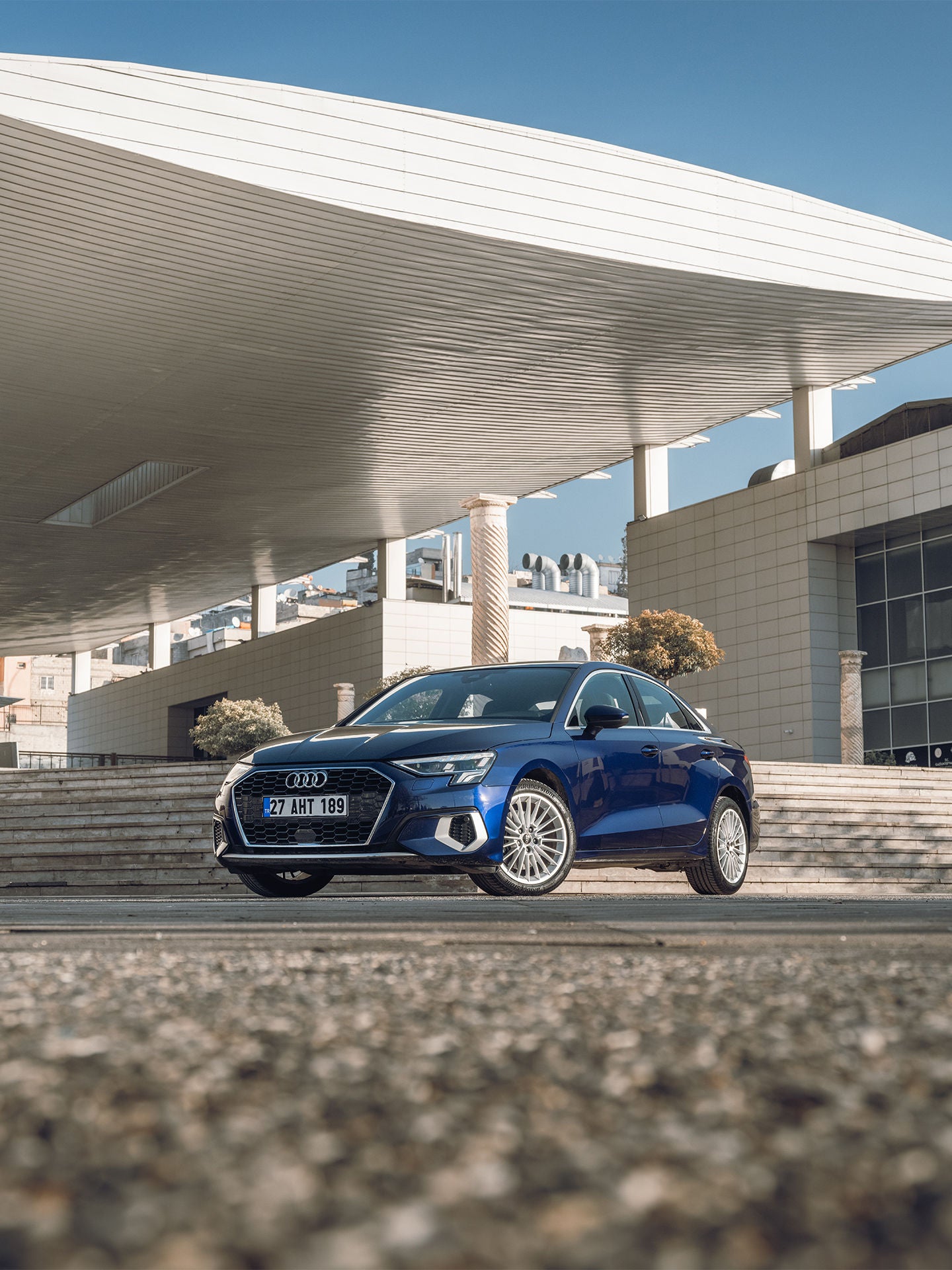 Audi RS e-tron GT sports car on a concrete surface in front of futuristic architecture