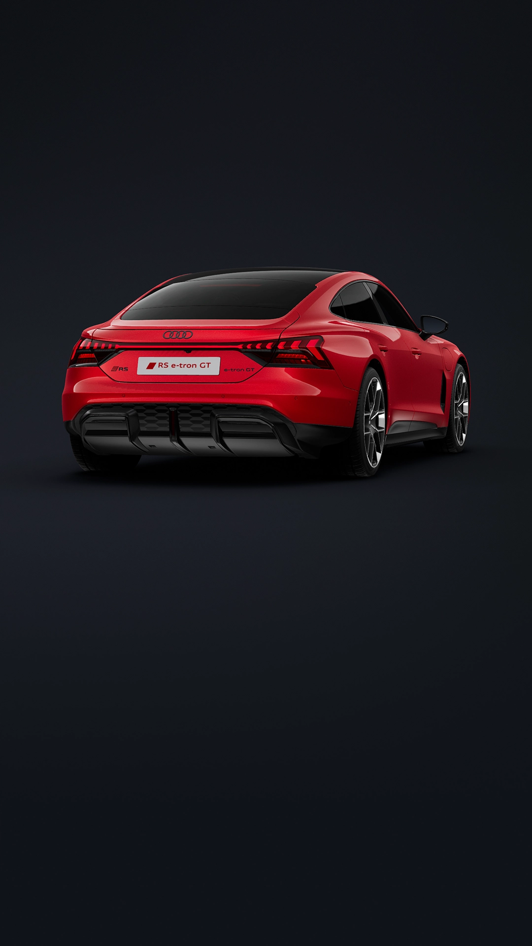 Grey Audi RS e-tron GT car rear quarter, red brake lights on, black wheel and road.