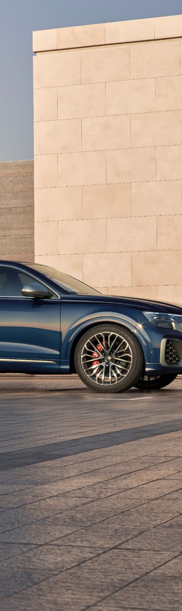 Side rear view of Q8 SUV with model