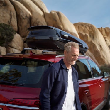 The Audi Q7 in the background with travel luggage