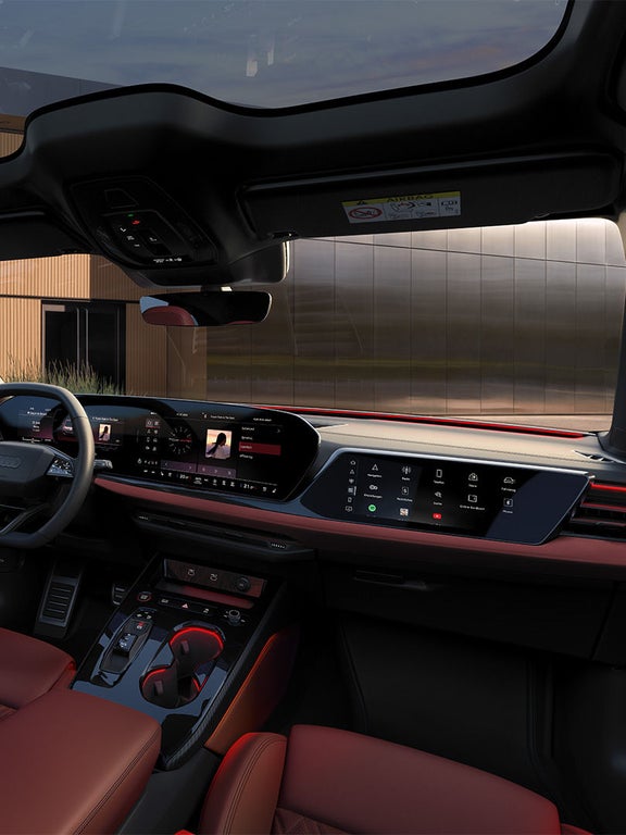 Innenraum des Audi S5 Avant mit rotem Leder, Ambientebeleuchtung und zwei großen Displays im Armaturenbrett.