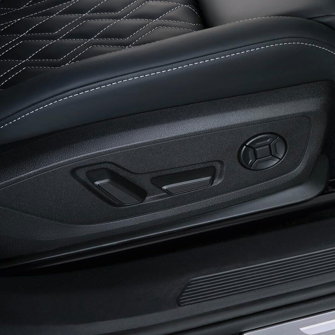 Black leather Audi Q4 e-tron seat with white stitching, featuring window and seat controls.