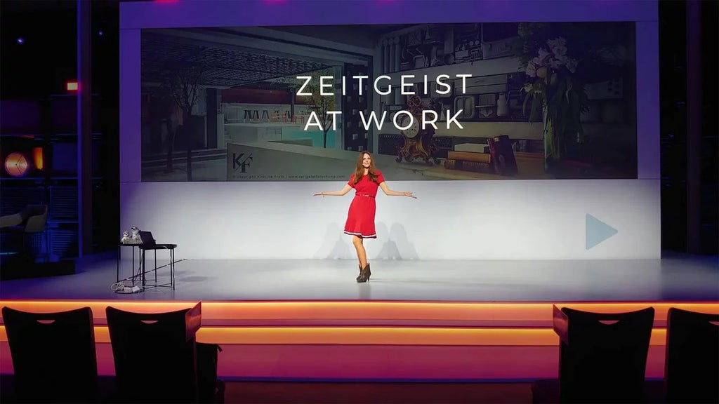 Kirstine Fratz is on stage in a red dress.