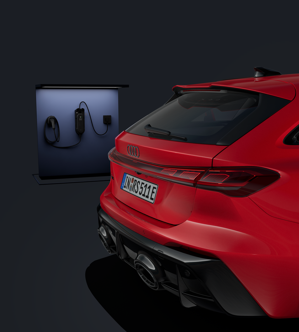 Focus on the rear of the RS 5 Avant, with a charging station in the background.