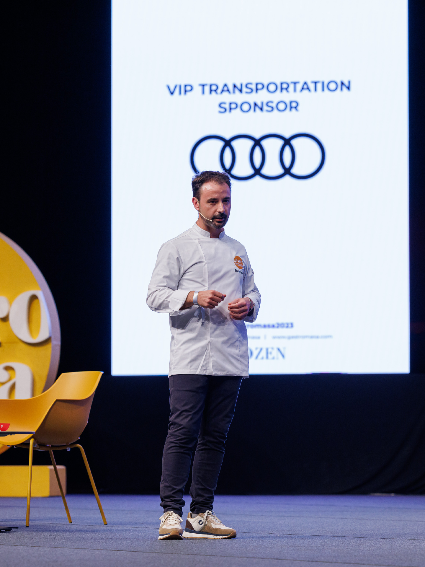 Audi RS e-tron GT sports car on a concrete surface in front of futuristic architecture