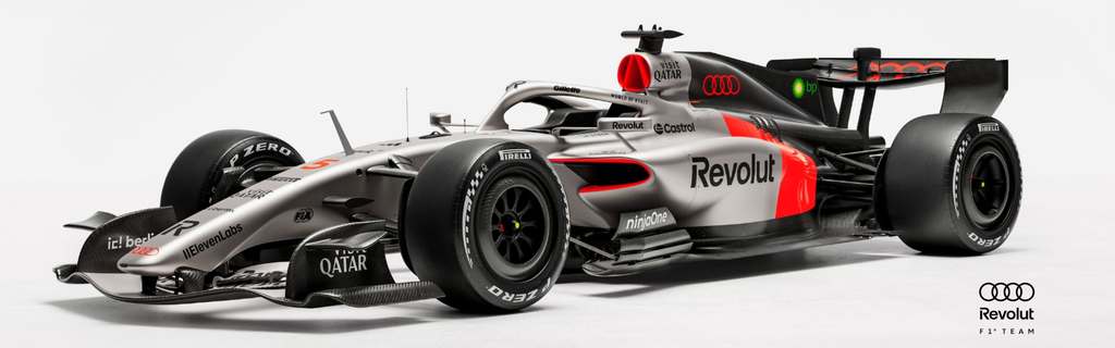 An Audi Formula 1 car is parked in front of a white wall