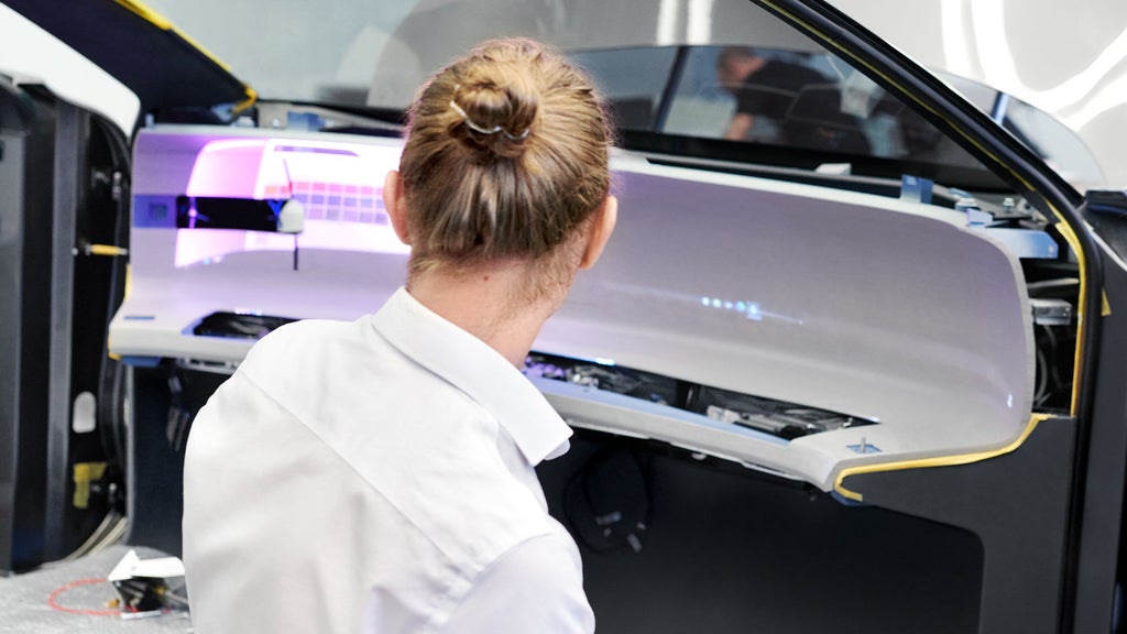 An Audi designer looks at a stage in the development of the Audi grandsphere concept¹ interior.