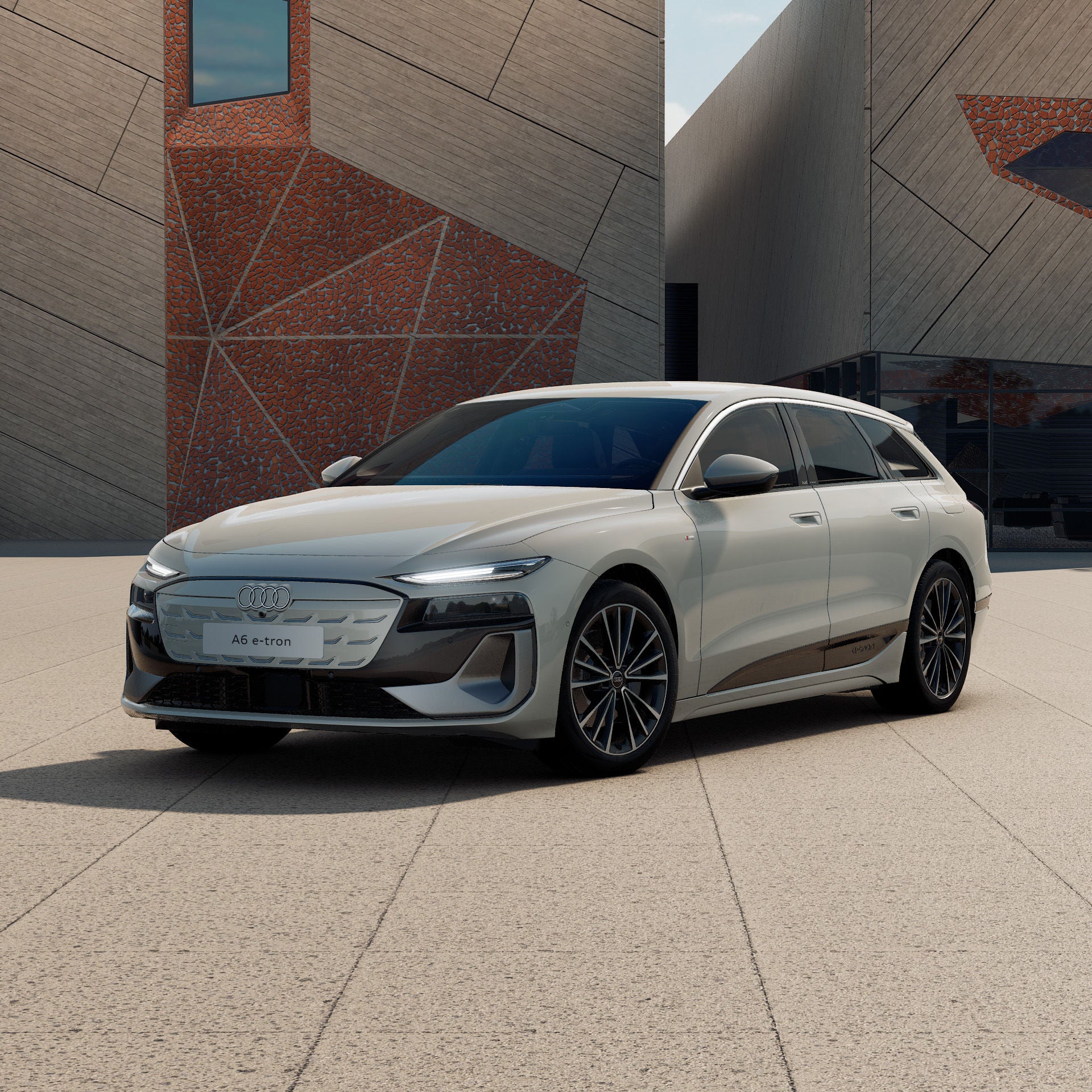 Ein Audi A6 Avant e-tron in Siambeige Metallic schräg von vorne fotografiert vor einer futuristischen Kulisse