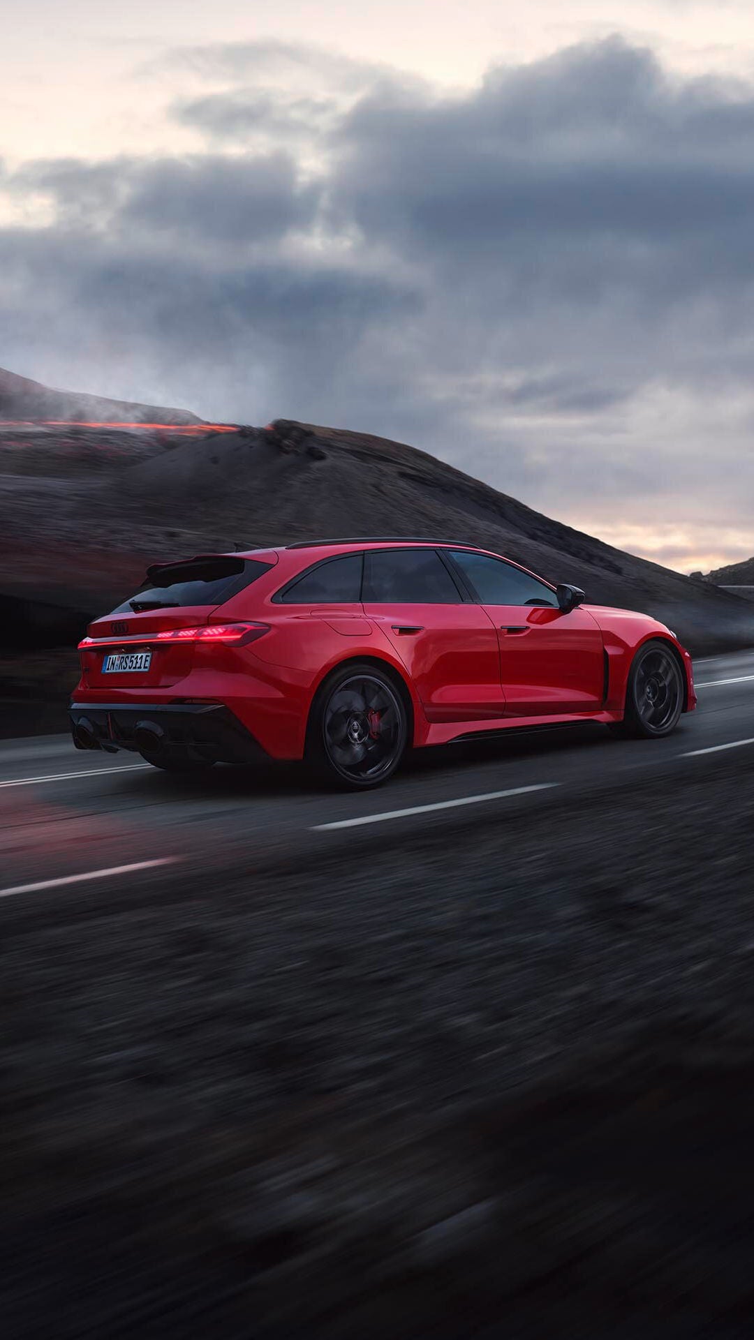 The RS 5 Avant driving against a backdrop of mountains