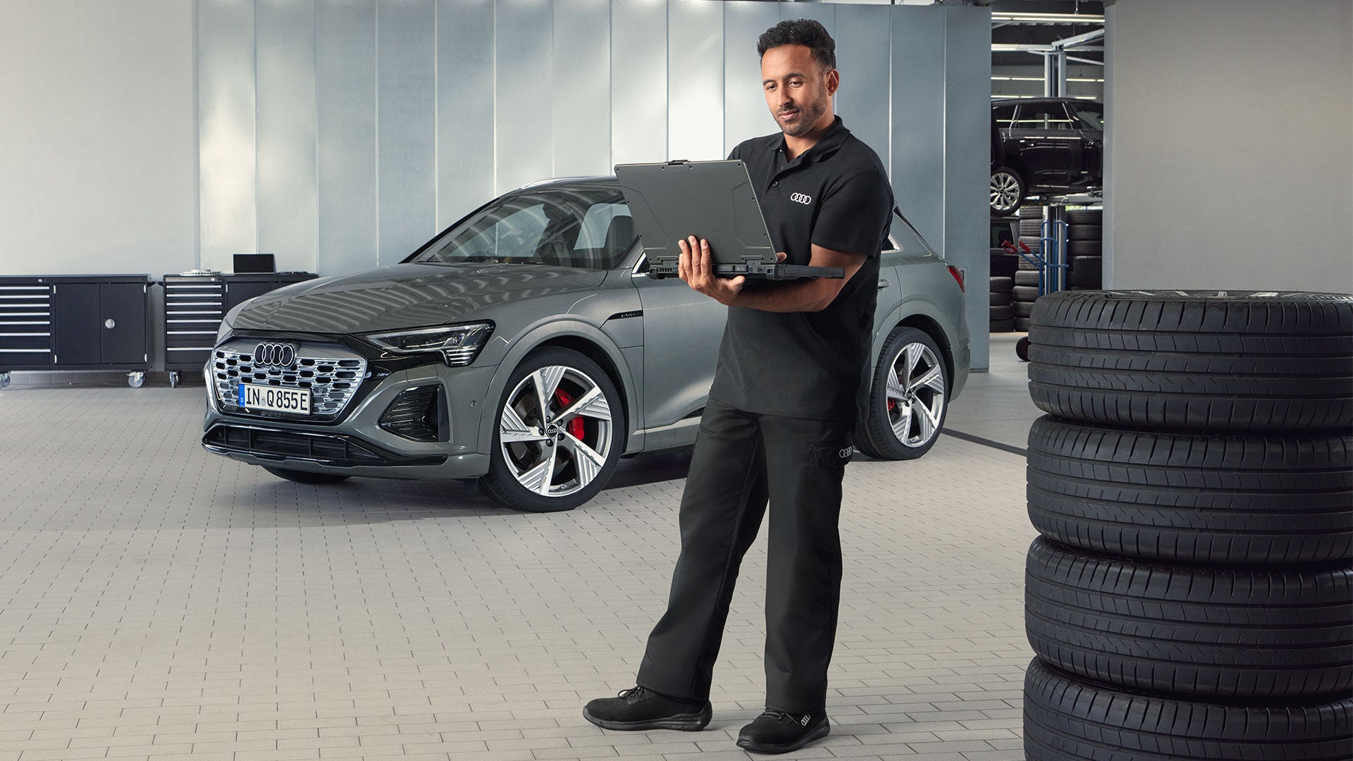 Close up of a man walking near an Audi
