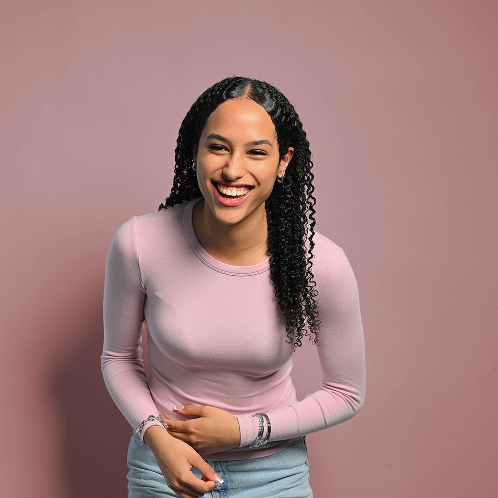 Lisa-Marie ist nach vorne gebeugt und lacht in die Kamera