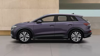 Side view of a purple Q4 e-tron parked against a beige wall. The vehicle has modern styling and polished chrome wheels, conveying luxury.