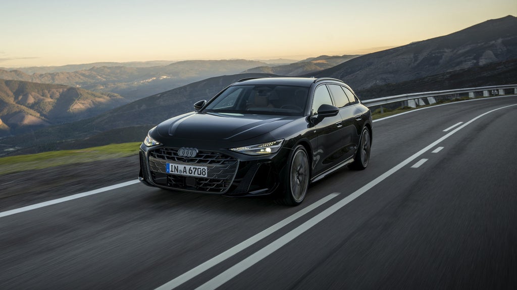 The all-new A6 Avant driving along a country road.