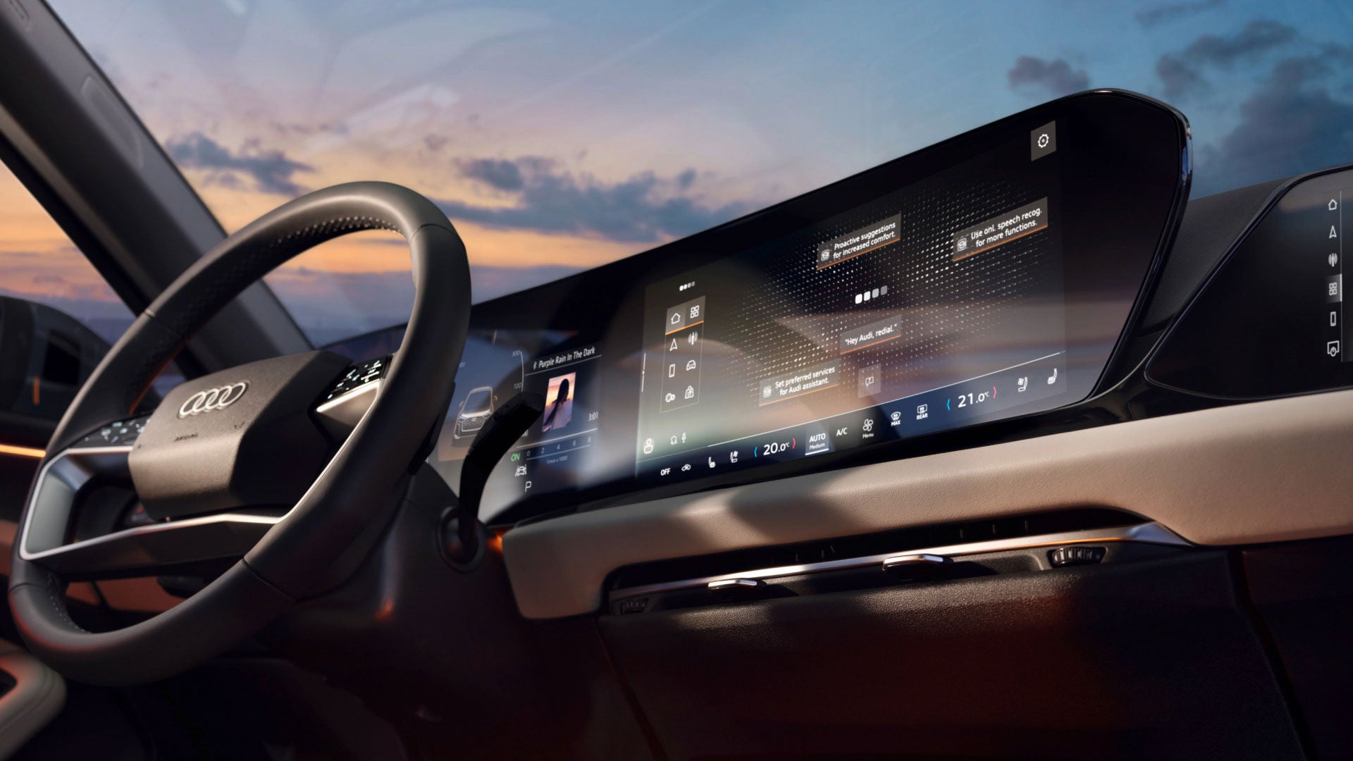 Digitales Cockpit eines Audi bei Sonnenuntergang mit großem gebogenem Display und Touchbedienung.