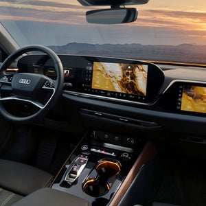 Interior of an Audi car with a yellow marble light theme