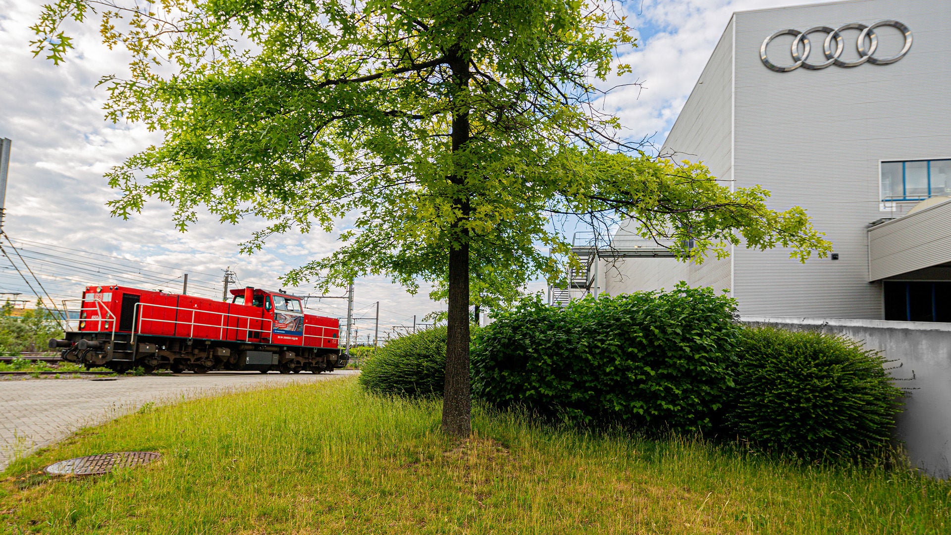 A train next to the Audi Brussels Factory