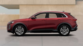 A red Q5 SUV e-hybrid parked against a textured beige backdrop, showcasing its modern design and sporty features from a side view.