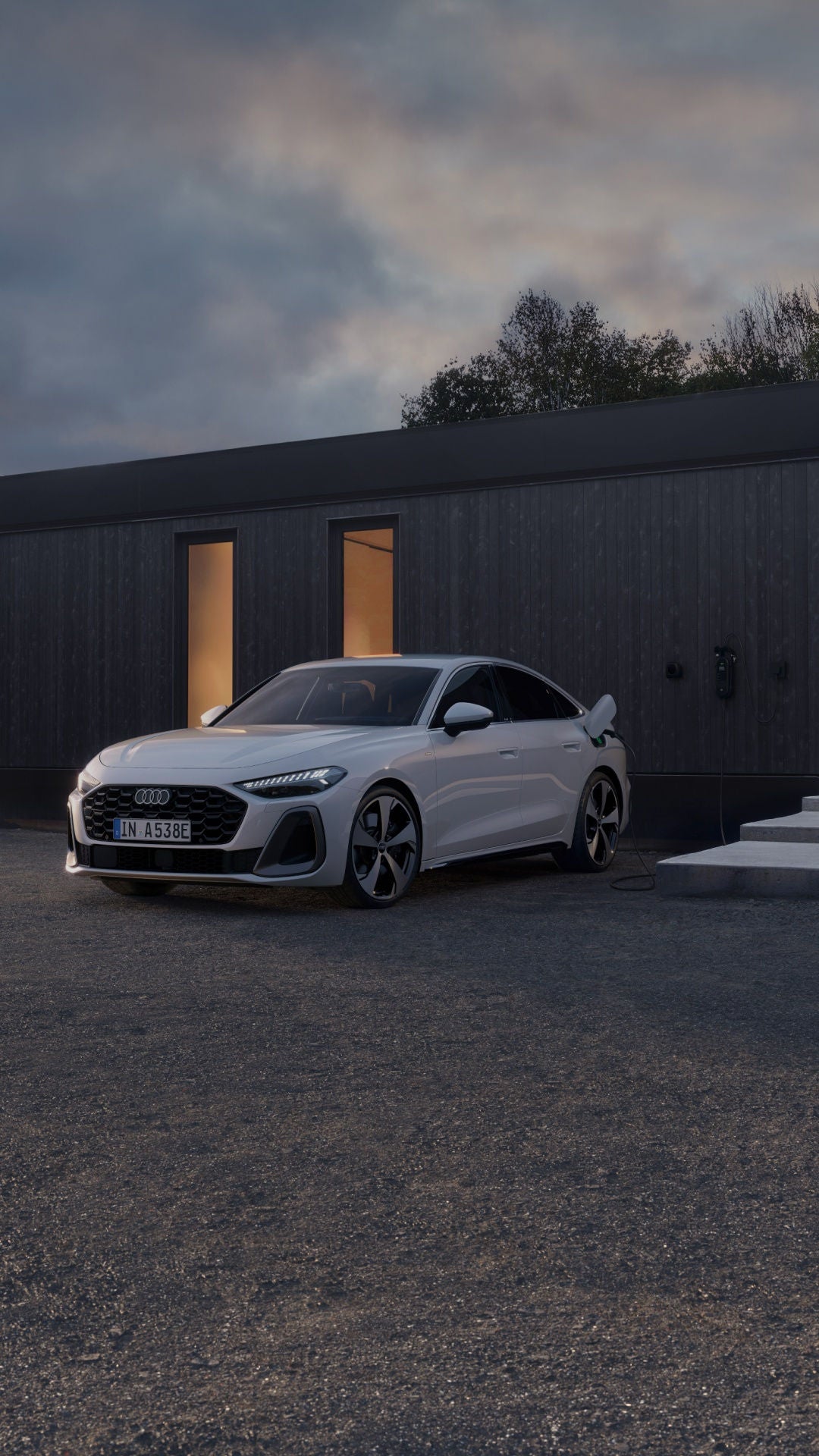 Audi car parked near waterfront outside modern cabin