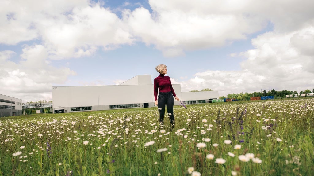 Dr. Antje Arnold, Head of Corporate Environmental Protection at Audi, stands in a meadow on the Audi site in Münchsmünster. 