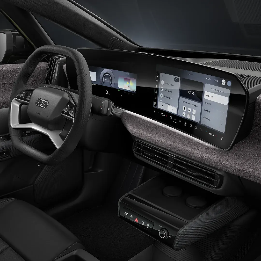 Interior view of the Audi A2 e-tron electric car dashboard showing digital displays and steering wheel