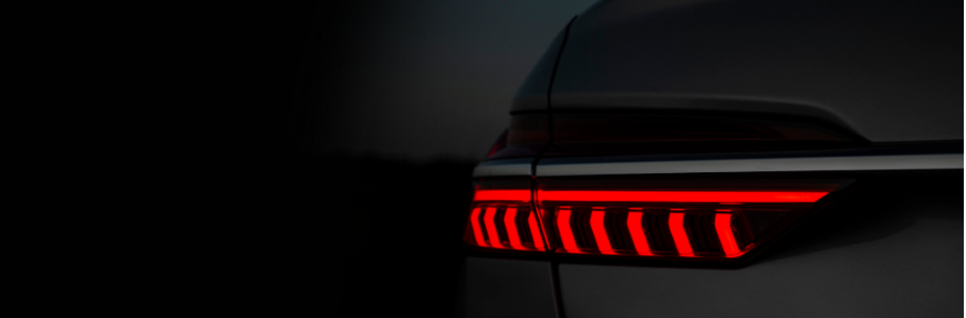 Close-up of a an Audi red LED tail light illuminated in the dark