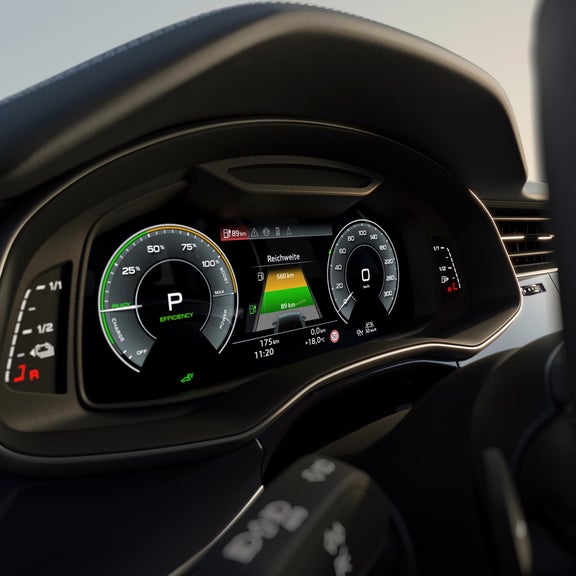 Digital car dashboard displaying battery level, range, and speedometer with modern design.