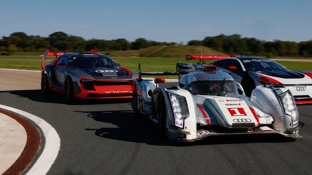 Three Audi sports car racing on track