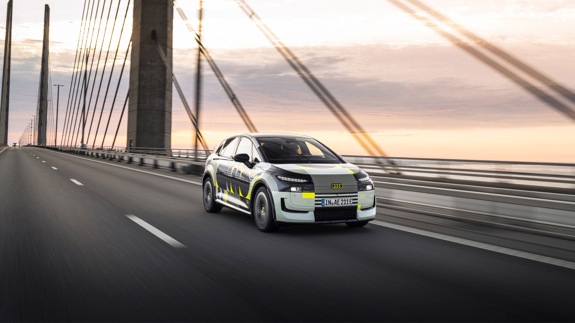 Audi A2 e-tron driving across a bridge
