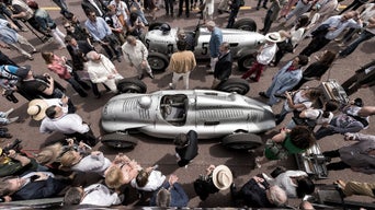 Bird's eye view of a crowd of people standing around Audi models