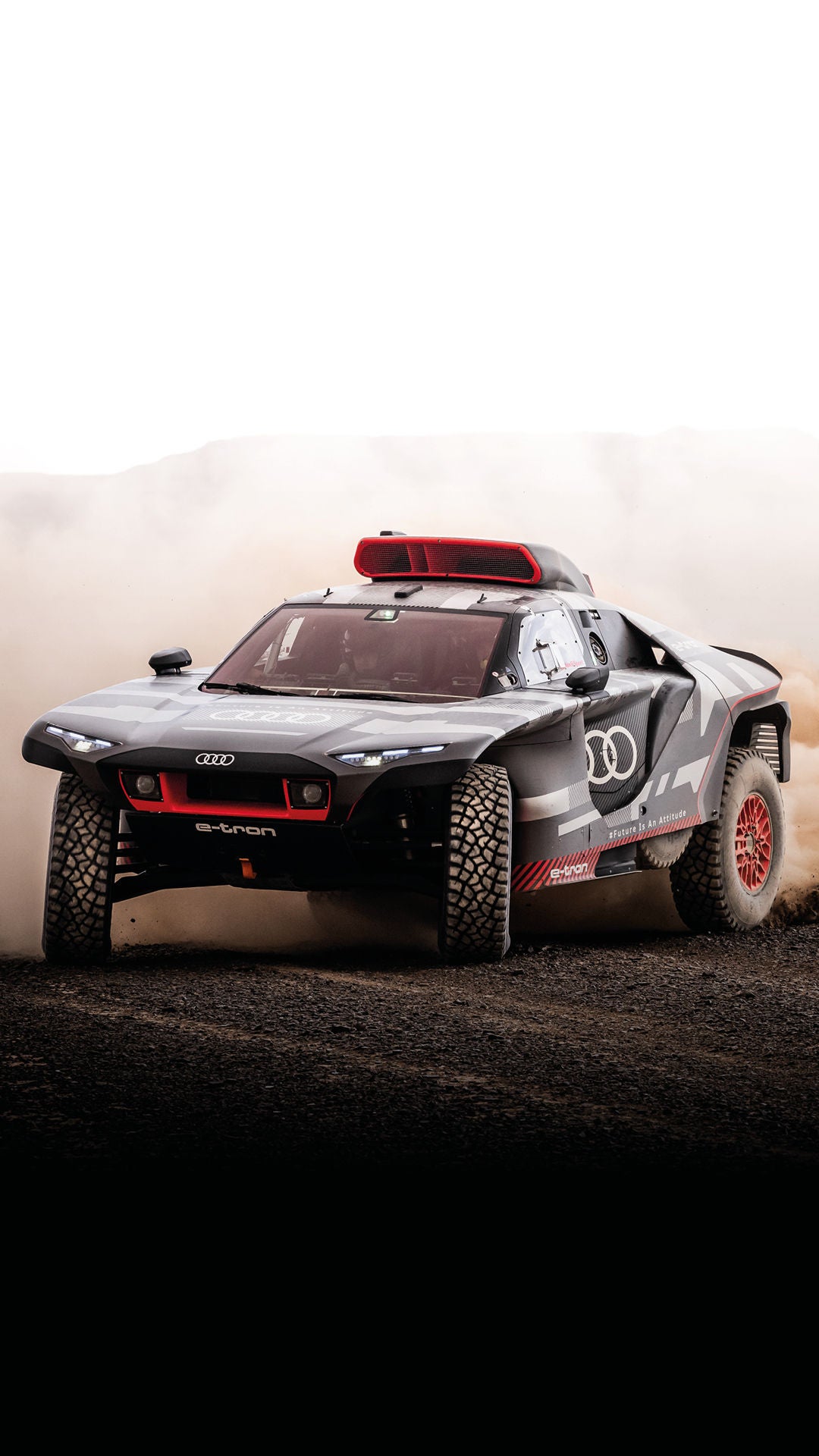 The Audi RS Q e-tron crosses a desert landscape.