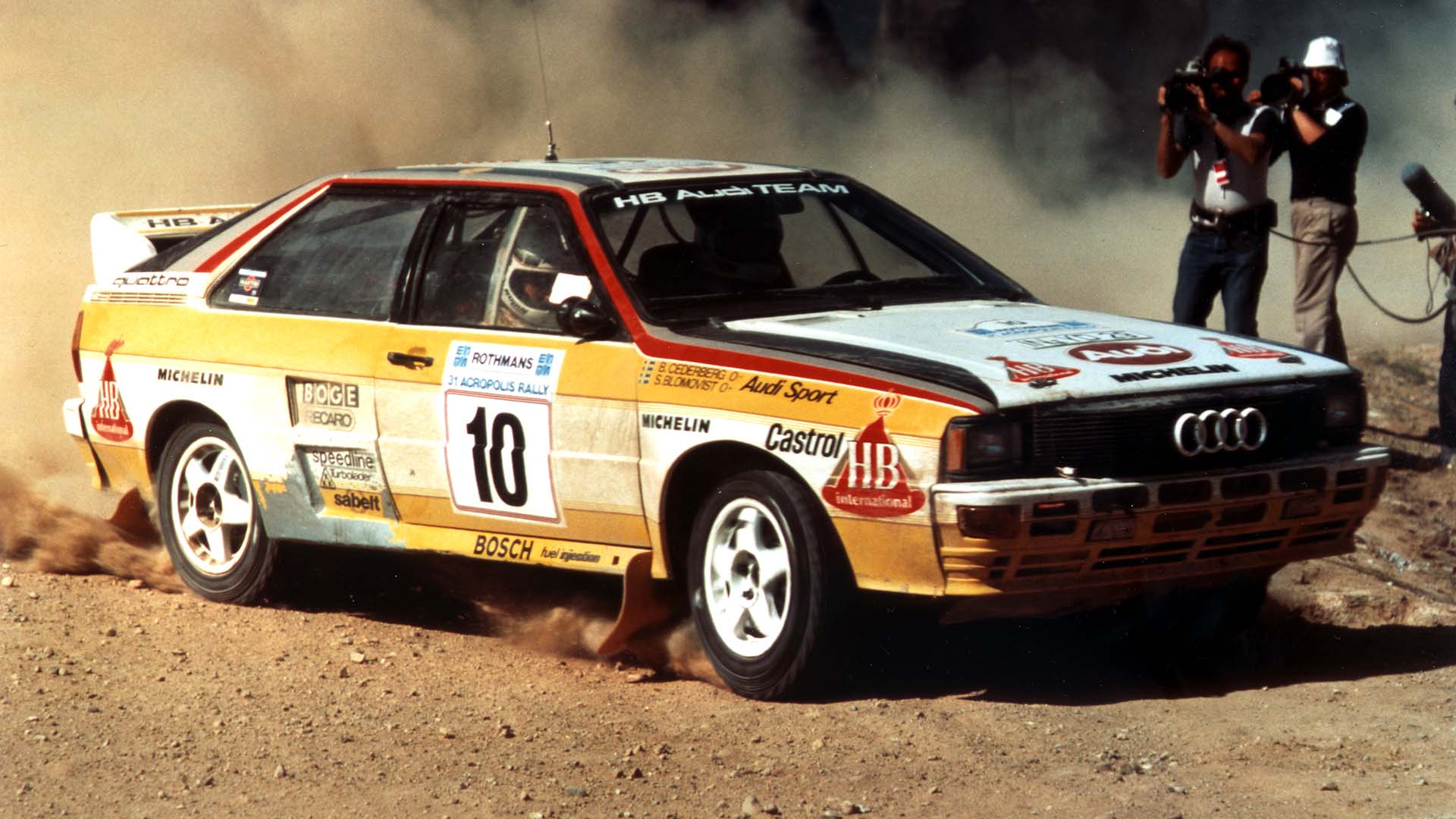 A picture showing an Audi quattro A2 rally car on gravel.
