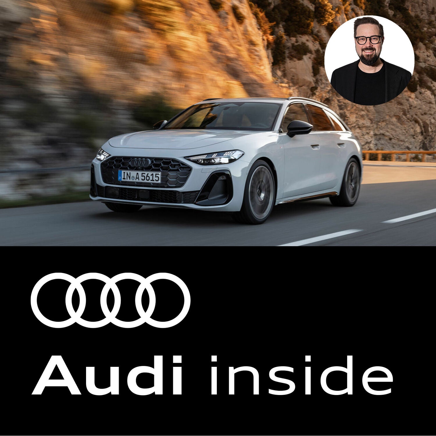 Nahaufnahme eines weißen Audi auf einer Serpentine mit Felswand im Hintergrund.