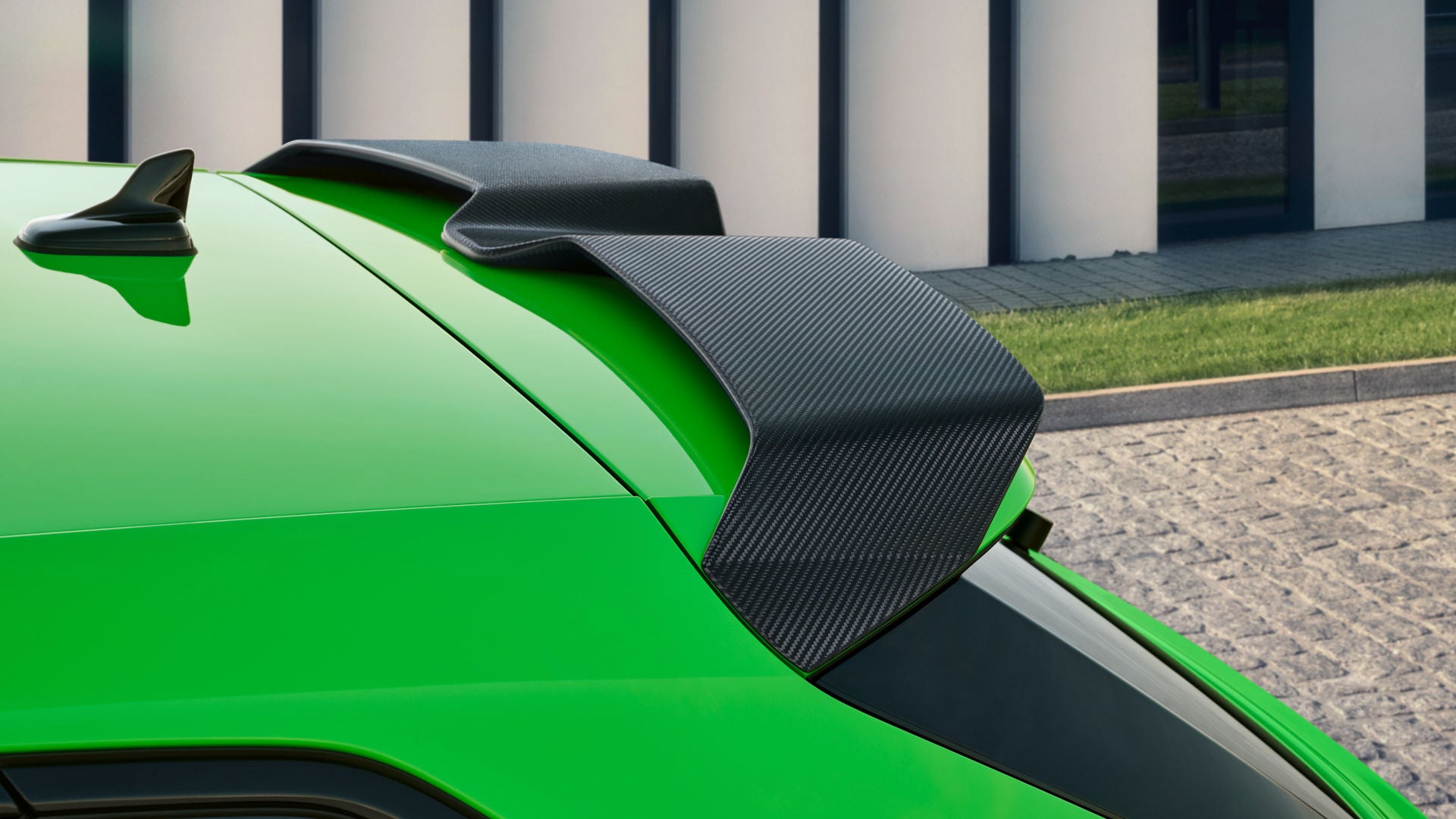 A view of the rear of the Audi RS 3 saloon, focusing on the carbon-fibre tailgate spoiler.