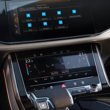 Display console showing gear shifter and touch screen display.