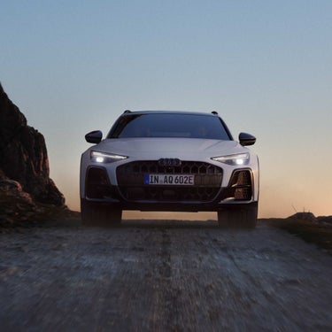 front view of A6 allroad e-hybrid driving down desert road