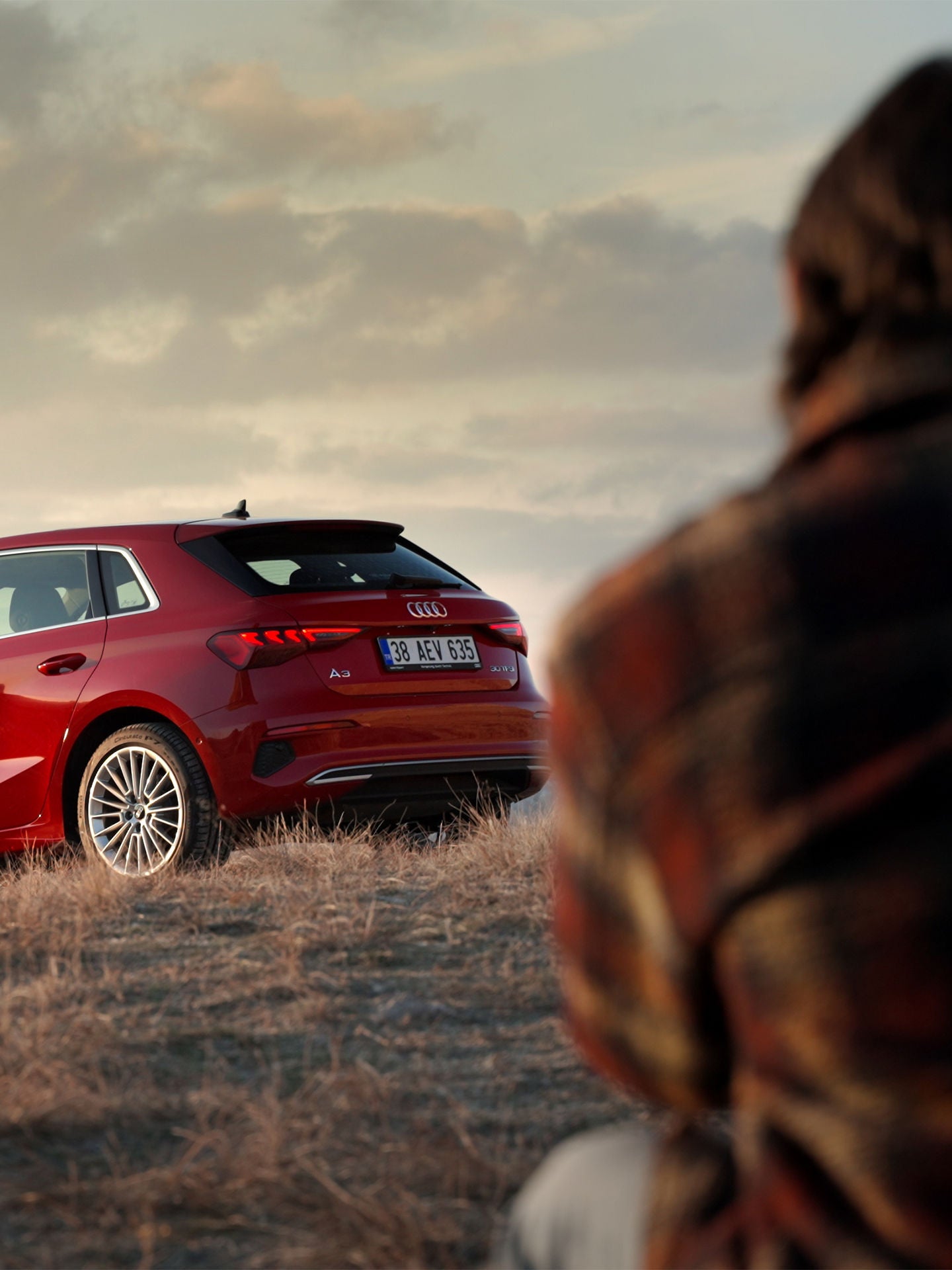 Audi RS e-tron GT sports car on a concrete surface in front of futuristic architecture