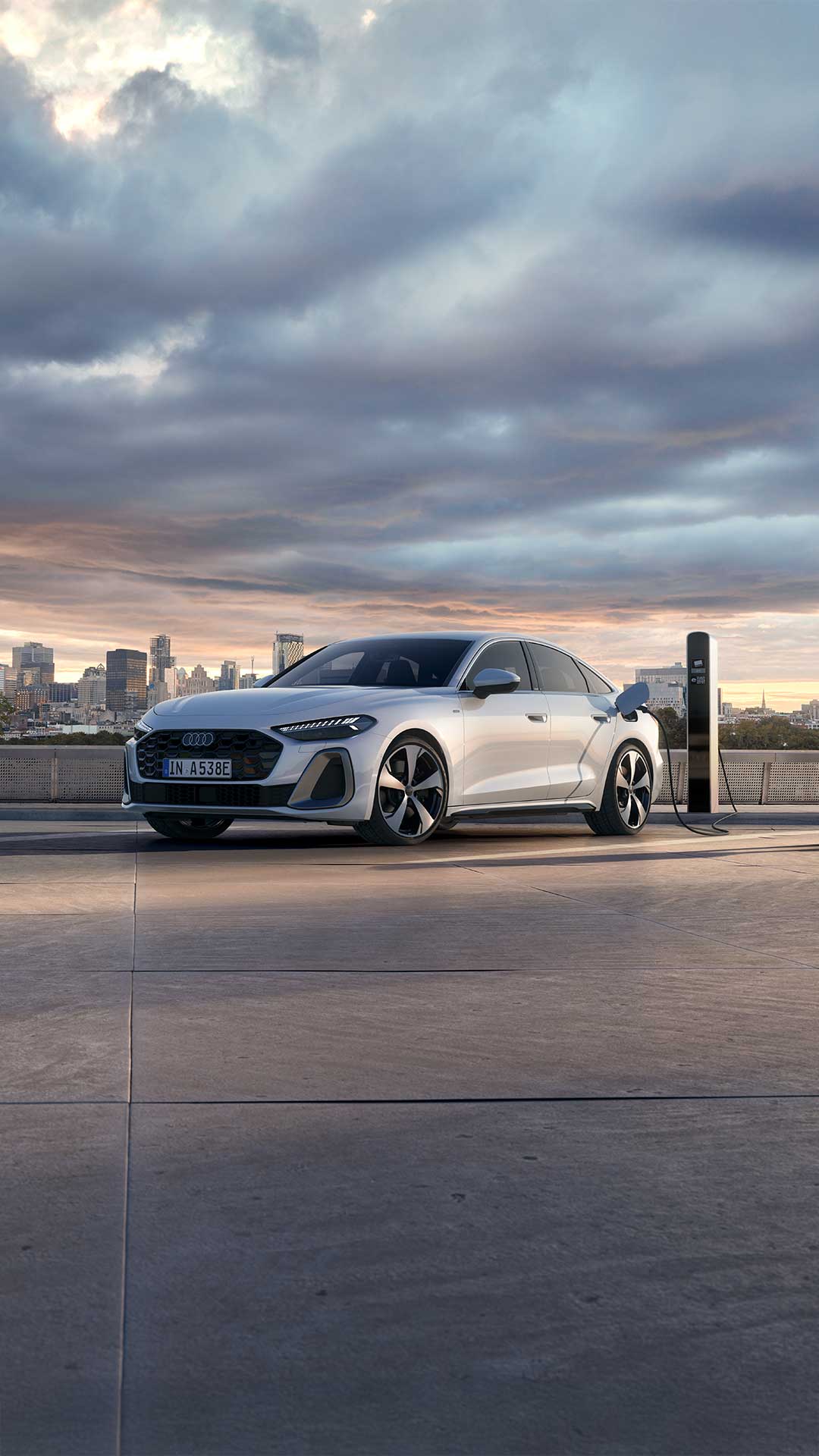 Audi A5 Sedan e-hybrid Charging. Standing next to the charging station