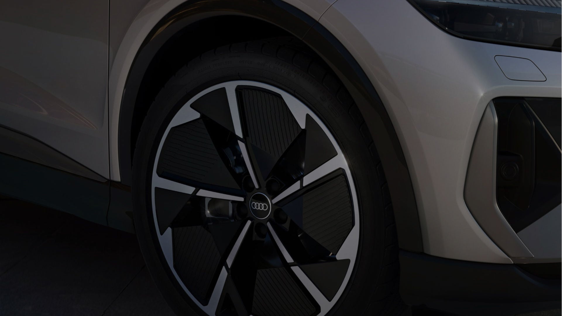 Close-up of an Audi vehicle’s stylish black and silver wheel, showcasing a sleek design and modern aesthetics.