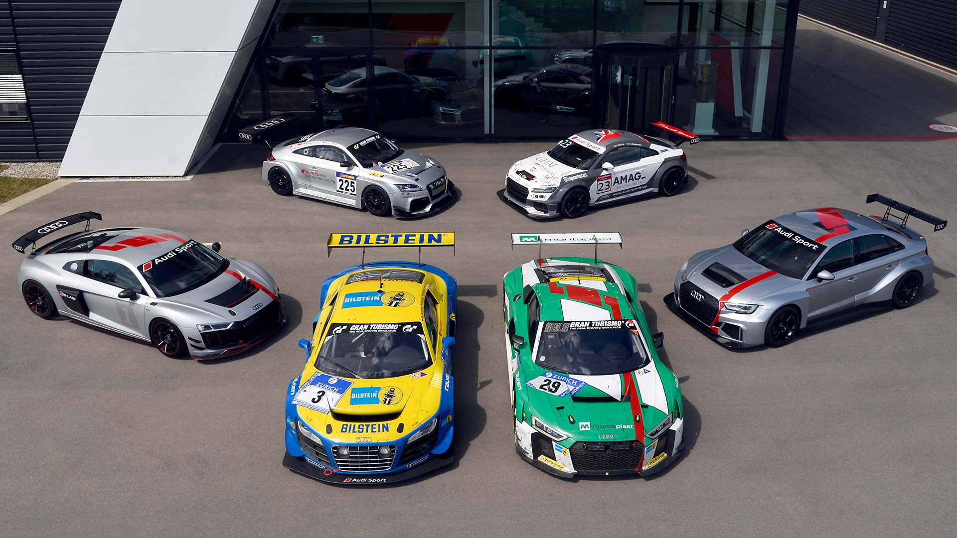 A picture showing a collection of six race cars from the history of Audi Sport customer racing.